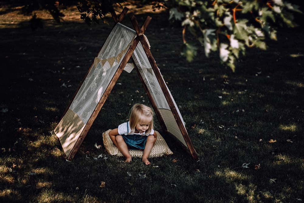 little girl in teepee